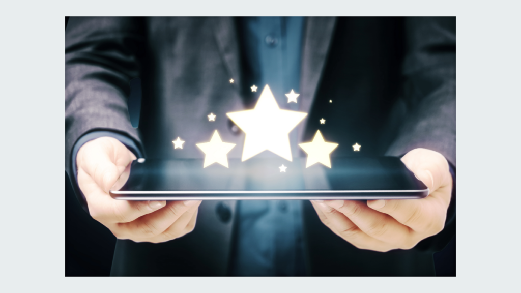 A person holding a tablet with three stars above the screen